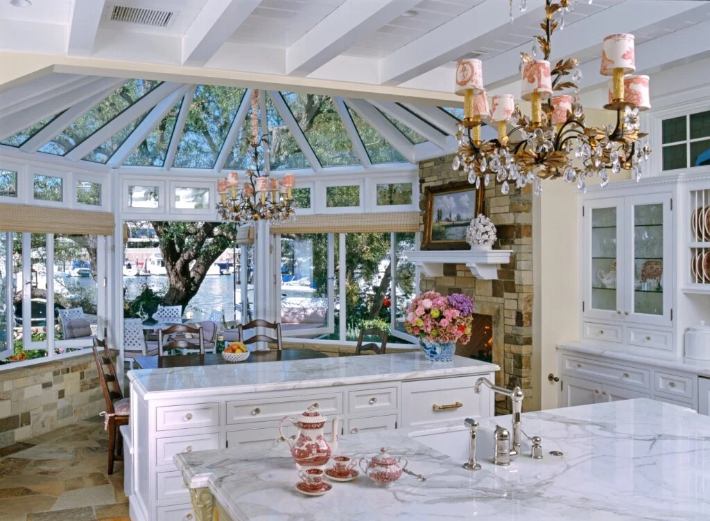 A lovely traditional kitchen with white cabinets and a breakfast area that doubles as a sunroom. Designed by Mark Cutler Design.