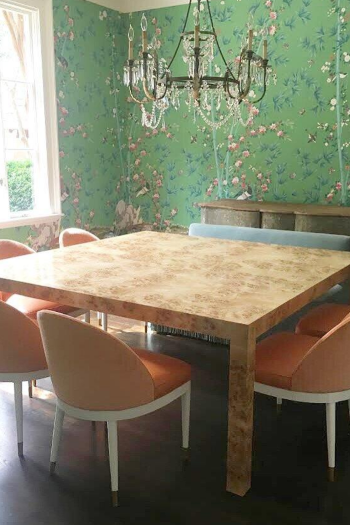 A Parsons table surrounded by orange modern chairs.